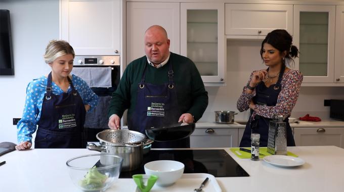 group of adults cook in the kitchen with Barnardo's