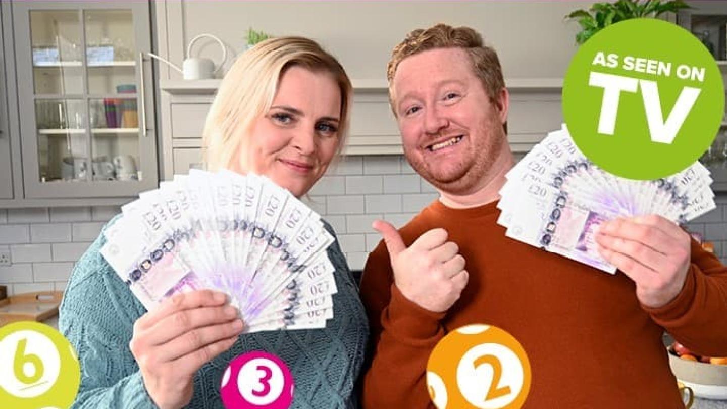 A couple holding their lottery winnings with a green circle that says "as seen on TV"